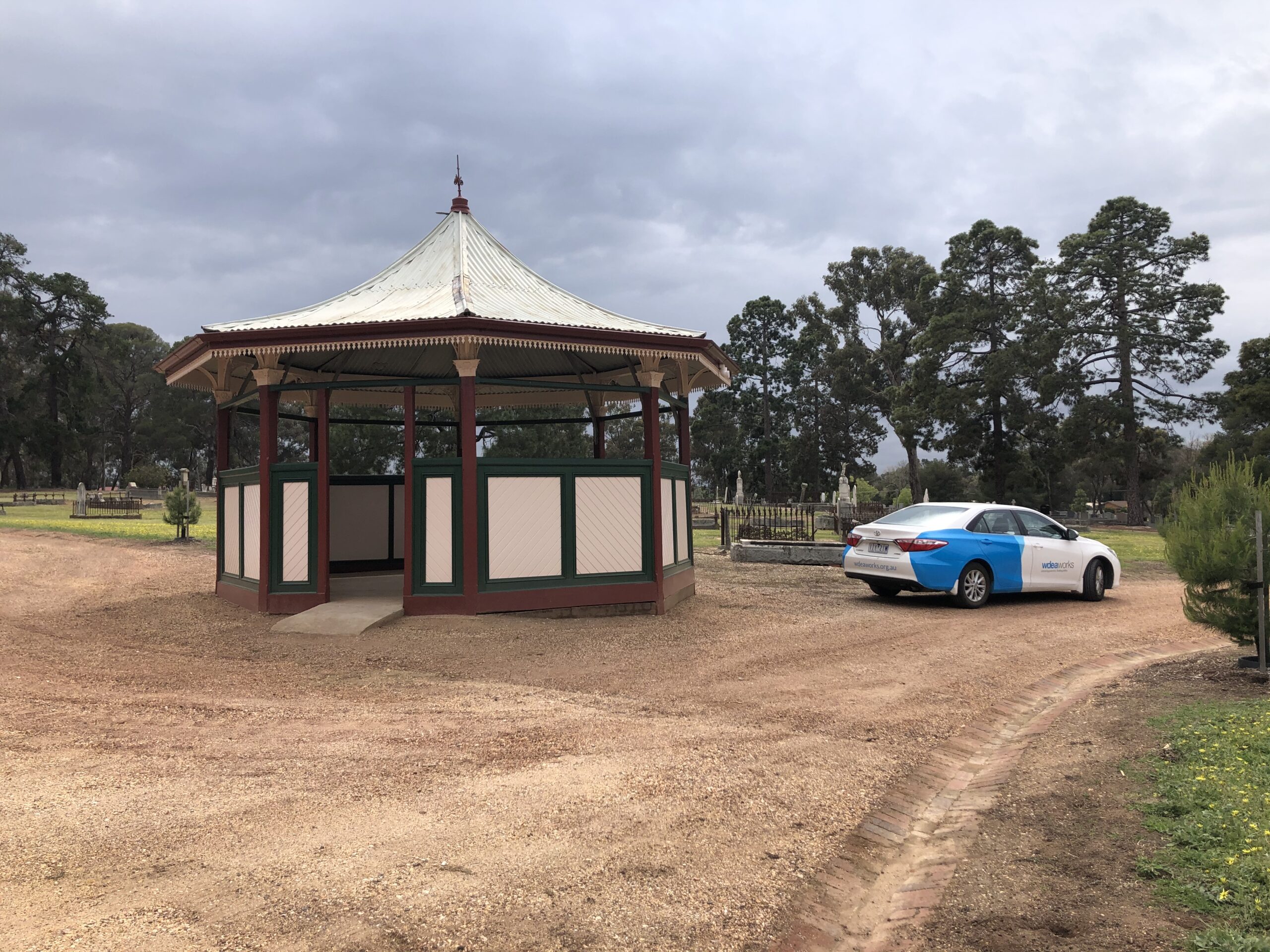 The restored rotunda with a WDEA Works car parked beside it. 